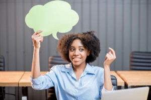 Portrait of creative african ethnicity businesswoman sitting with thought bubble at the office