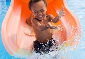 Boy on water slide
